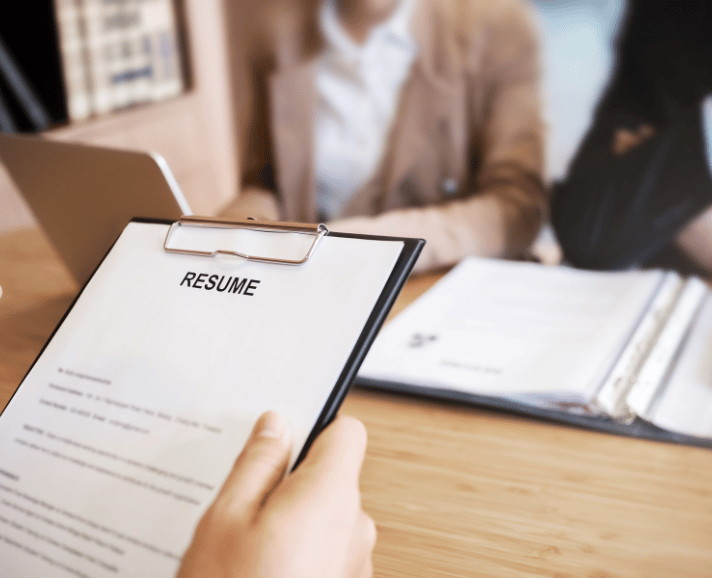 Unicorn Soft Labs Recruitment Agency Member holding Resume